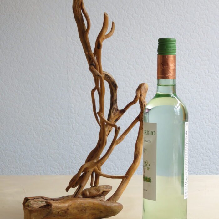 Ivy and hardwood Handcrafted wooden sculpture combing naturally shaped hardwood and Ivy .