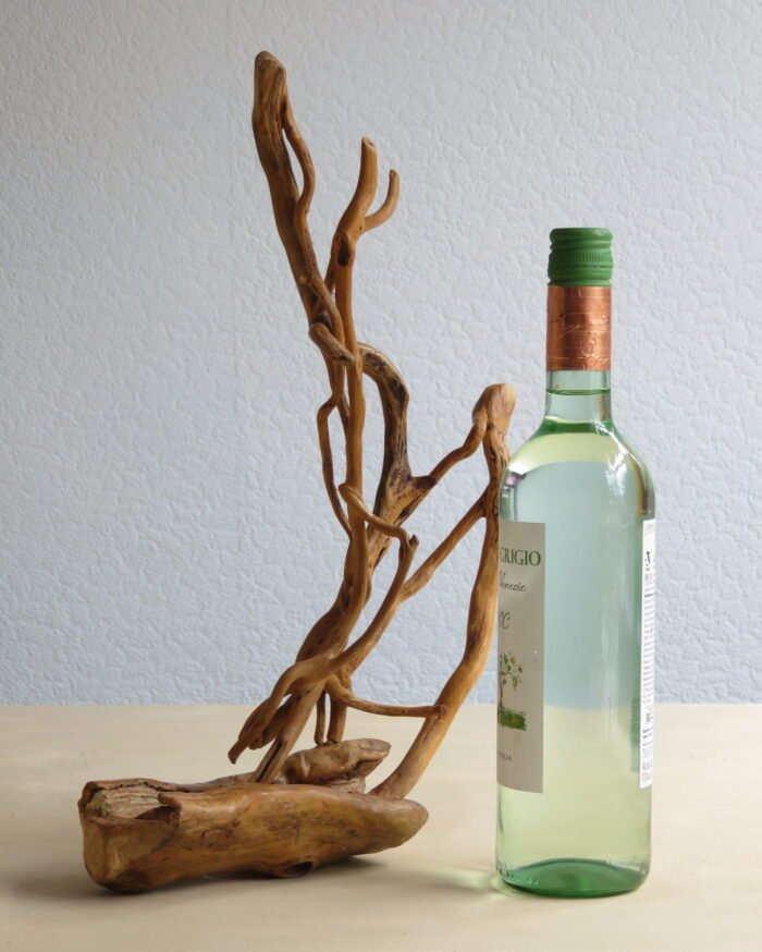 Ivy and hardwood Handcrafted wooden sculpture combing naturally shaped hardwood and Ivy .