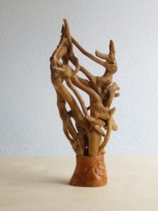 A free-standing, sculpture, hand crafted, combining Ivy and hardwood