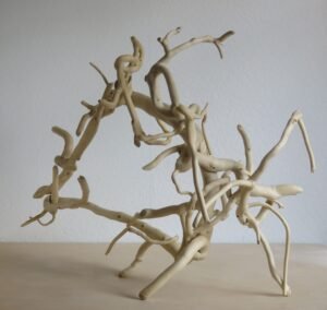 A versatile hand crafted wooden sculpture that can be used to hang things on as well as decorative.