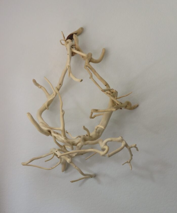 A unique and versatile wooden sculpture that can be free standing or hung.