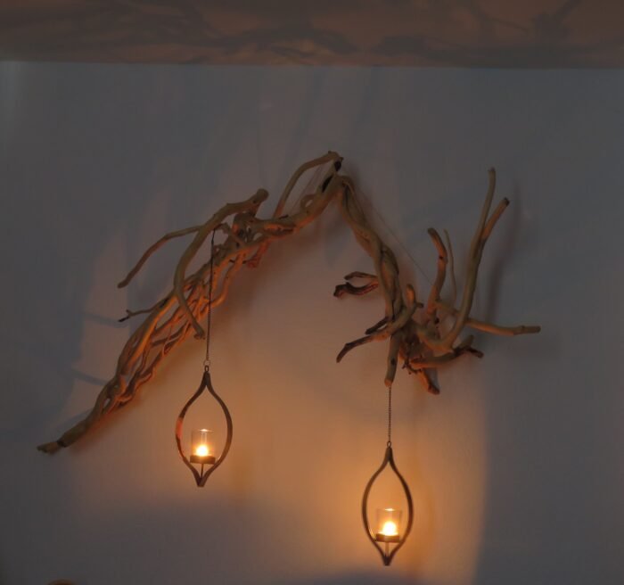 Wall hanging with lanterns A unique wooden sculpture that comes to life with movement in candlelight.